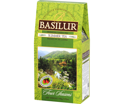 Zielona herbata Basilur Summer Tea w opakowaniu z motywem letniego krajobrazu.