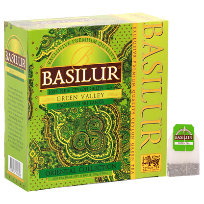 Herbata zielona Basilur Green Valley 100 sztuk z pokazanym opakowaniem oraz pojedynczą torebką herbaty.