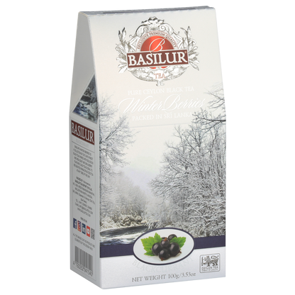 Opakowanie herbaty Basilur Blackcurrant 100 g z motywem ośnieżonych drzew i owoców porzeczki.