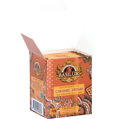 Otwarta paczka Basilur Caramel Dream z widocznymi kopertami herbaty czarnej