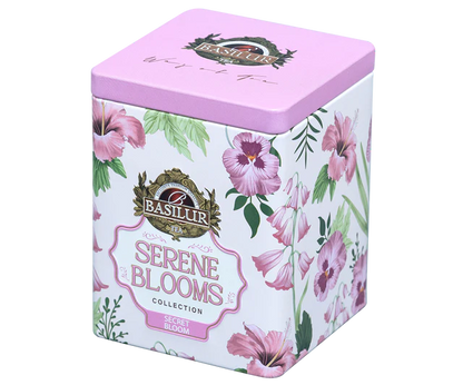 Elegancka puszka Basilur Secret Bloom ozdobiona różowymi kwiatami z widoczną etykietą.
