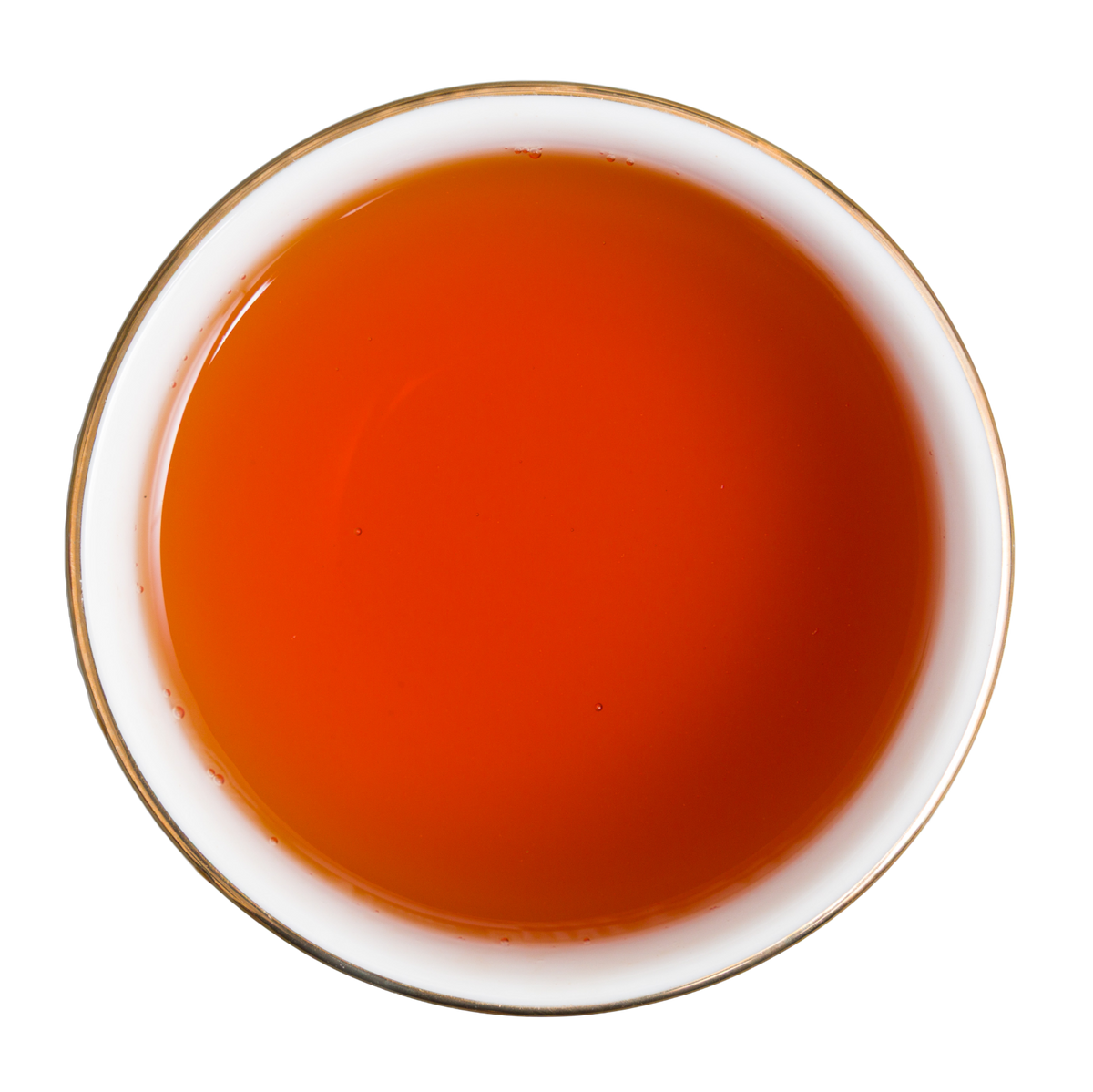 Bursztynowo-czerwony napar herbaty czarnej Basilur Red Apple And Yuzu widziany z góry.